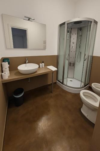 a bathroom with a sink and a shower and a toilet at Vico 4 Charme Apartments in Trieste