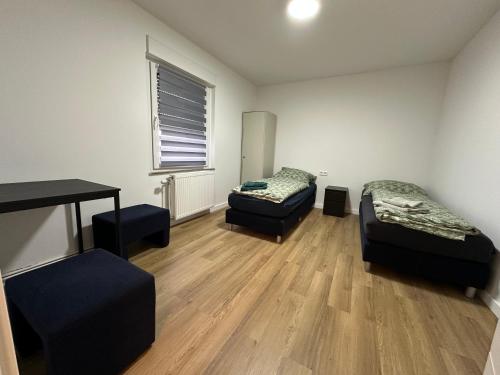 a room with a desk and a bed and a table at Grenz Oase in Gronau