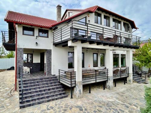 a house with a staircase in front of it at Diplomat Villa in Baile Felix