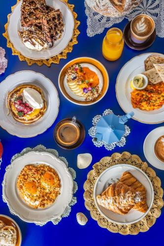 a blue table with plates of food on it at Beach Walk Boutique Jumeirah in Dubai