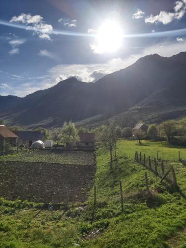 a view of a field with mountains in the background at Boga Cabins in Bogë