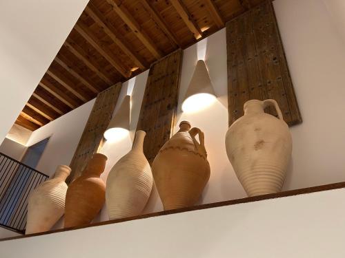 a group of vases sitting on a shelf at Casón del Conde in Orgaz