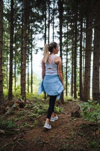 a woman is standing in the woods at Boutiquehotel DAS ZEITWERT in Deutschlandsberg