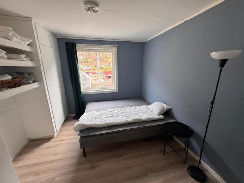 a small room with a bed and a window at Apart, 4 pers, Central in Odda in Odda