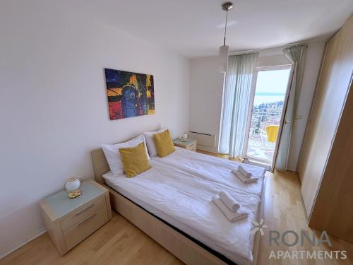 a bedroom with a bed and a large window at Rona Spacious apartment with a panoramic view in Ičići
