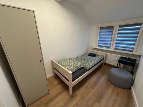 a small bedroom with a bed and a mirror at Grenz Oase in Gronau