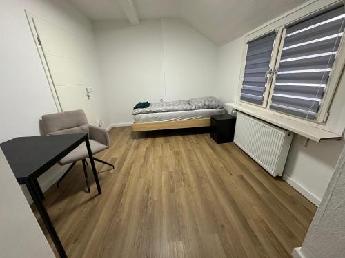 a room with a bed and a desk and a window at Grenz Oase in Gronau