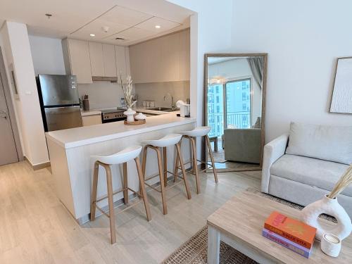 a kitchen and living room with a counter and a couch at 2 Bedroom In Waters Edge Voyage in Yas Island