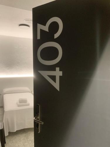 a door to a bathroom with a bed in a room at Hotel DL Urban in Castellón de la Plana