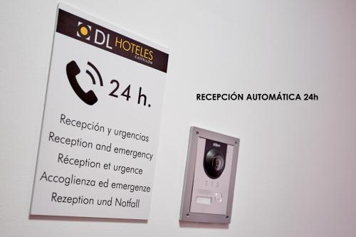 a sign on a wall with a camera on it at Hotel DL Urban in Castellón de la Plana