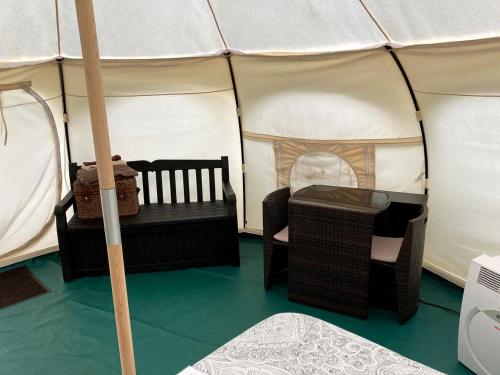 a tent with two chairs and a table in it at Fantastic Virginia Glamping Retreat near Charlottesville in Gordonsville
