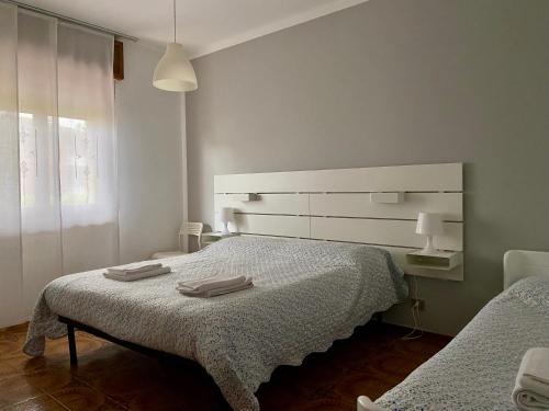 Postel nebo postele na pokoji v ubytování Casa Gaia- Castelnuovo del Garda