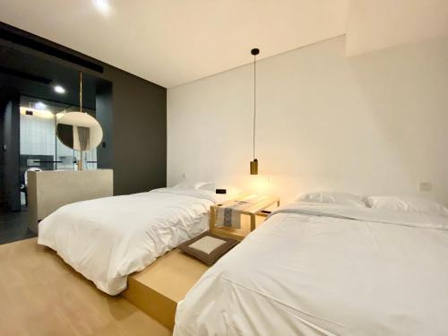 a bedroom with two beds and a mirror at the house of mo in Shanghai
