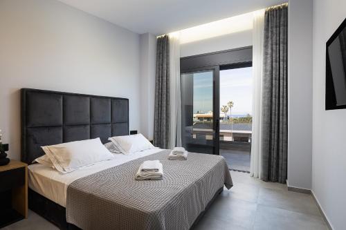 a bedroom with a bed with two towels on it at Resmi SeaView Villa,By IdealStay Experience in Kokkíni Khánion