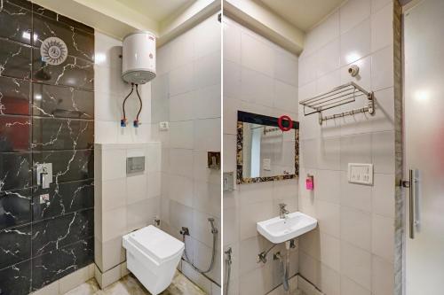a bathroom with a shower and a toilet and a sink at Collection O Model Town Metro View in New Delhi