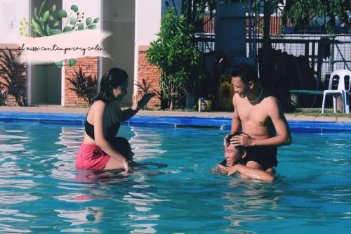 a man and a woman playing in a swimming pool at El Nissi Staycation, THE BARIQUIT SUITE, Enchanted Kingdom in Santa Rosa