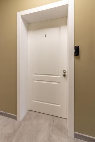 a white door in a room at E-home Apartments in Varna City