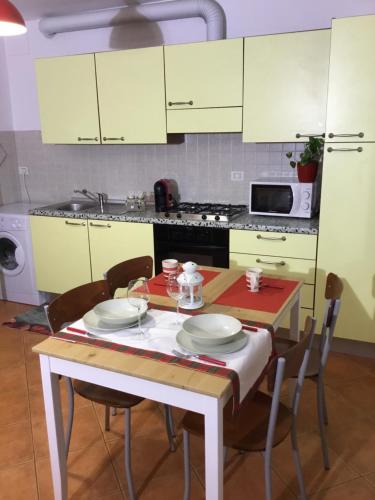 a kitchen with a table with chairs and a stove at Home Iseo Lake in Bossico