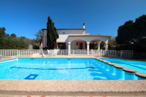 a large swimming pool with a house in the background at Can Canto Mediterranea x 6 pax in Sa Ràpita