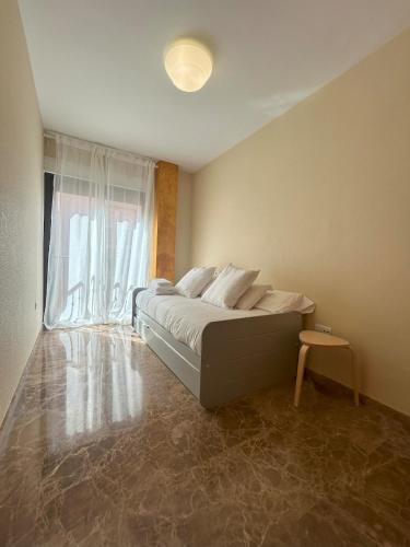a bedroom with a bed and a window at Living Home - Centro Ciudad in Murcia