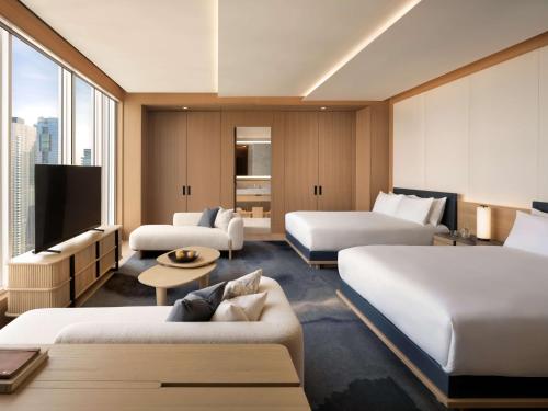 a hotel room with two beds and a flat screen tv at Nobu Hotel Toronto in Toronto