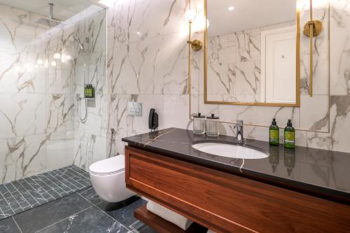 a bathroom with a sink and a toilet at Cheval Maison - Expo City Dubai in Dubai
