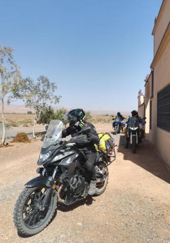 a group of motorcycles parked on a dirt road at Gite Amoudou in Ouarzazate