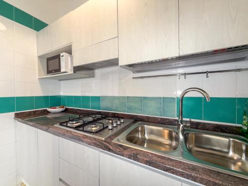a kitchen with a sink and a stove at Suites in the Amalfi Coast - GuestHouse with Terrace near Amalfi - Breathtaking View of Ravello in Scala