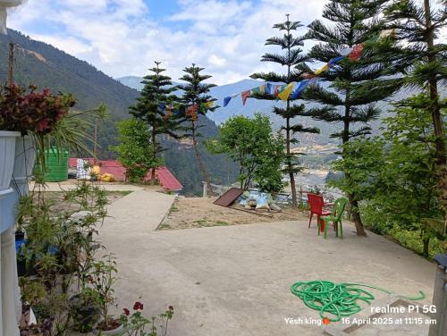 a pathway with chairs and a view of a mountain at DROIMA HOME Stay , NEAR TDL BUDDHIST MONASTERY ,DIRANG in Dirang Dzong
