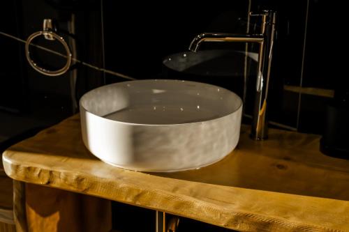 a white sink on top of a wooden table at Boutique Hotel Caramel in Syvota