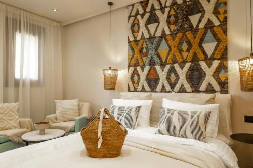 a bedroom with a white bed with pillows and a painting at Boutique Hotel Caramel in Syvota