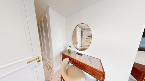 a bathroom with a toilet and a mirror at Cheval Maison - Expo City Dubai in Dubai