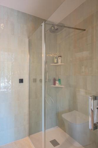 a shower with a glass door in a bathroom at Picasso Mountain View Begur in Begur
