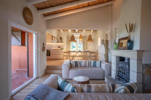 a living room with two couches and a fireplace at Picasso Mountain View Begur in Begur