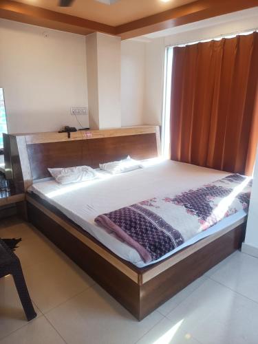 Postel nebo postele na pokoji v ubytování Hotel Asha Inn