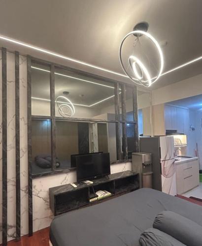 a living room with a large mirror and a couch at Pakuwon Orchard Tanglin Surabaya in Surabaya