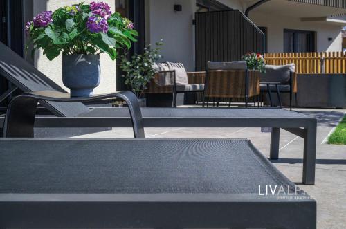 a table with a vase of flowers on top at LIVALPIN Comfort in Garmisch-Partenkirchen