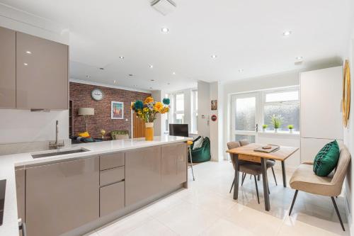 a kitchen with a table and a dining room at City Centre Maison in High Wycombe