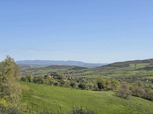 a view of a green field with mountains in the background at Manciano Holiday Apartments in Manciano