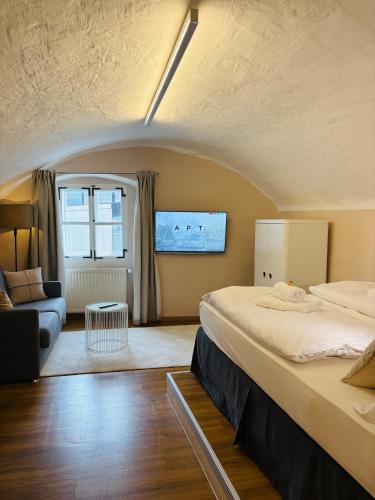 a hotel room with a bed and a couch at APT. STONE-LODGE in Salzburg