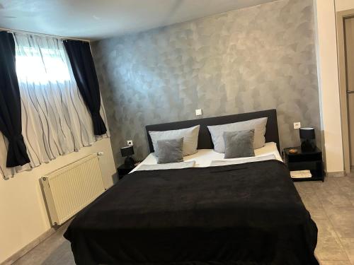 a bedroom with a large bed with two pillows at Mikroapartments Klarenthal in Saarbrücken