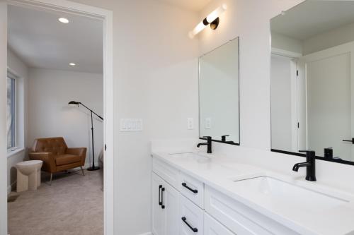 a white bathroom with a sink and a mirror at Lake Life At The Cove - Gateway To Summer Fun! in Lake George