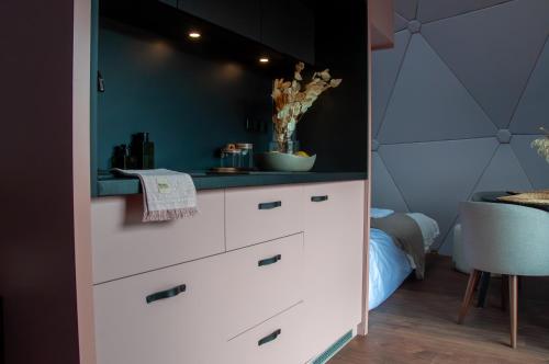 a kitchen with a white dresser in a bedroom at Amalia Glamp in Wierzchosław