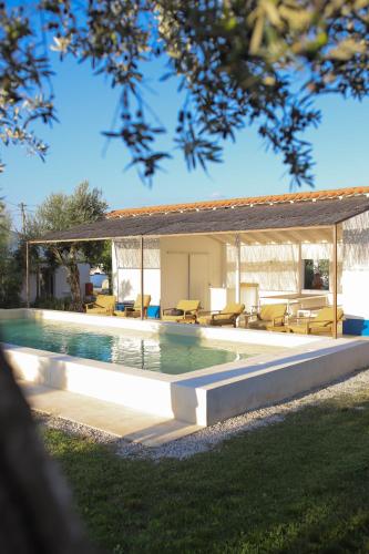 a swimming pool with a gazebo next to a house at São Brás do Regedouro - Turismo na Aldeia in Évora