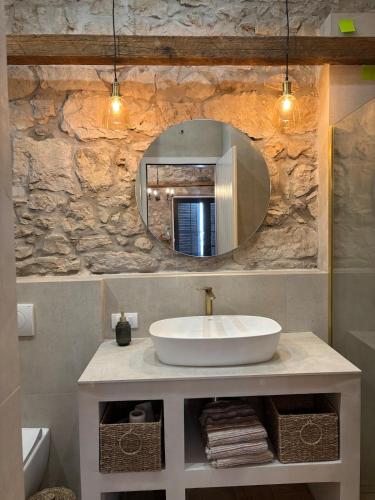 a bathroom with a sink and a mirror at Vila Espinosa in Trebinje