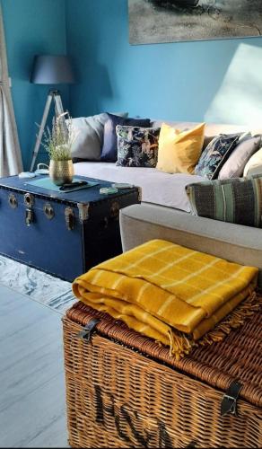 a living room with a couch and a table at Loughview Cottage in Bangor