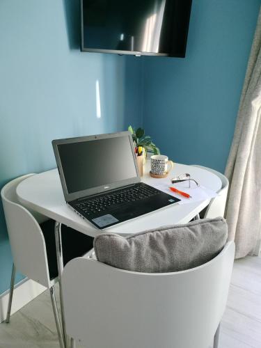 a laptop computer sitting on a white desk at Loughview Cottage in Bangor