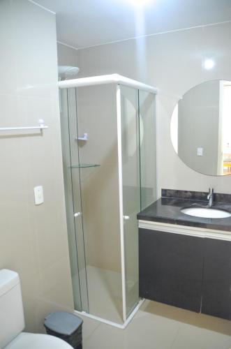 a bathroom with a glass shower and a sink at #204 Corais de Búzios - Apartamento à beira-mar na enseada de Búzios in Nísia Floresta