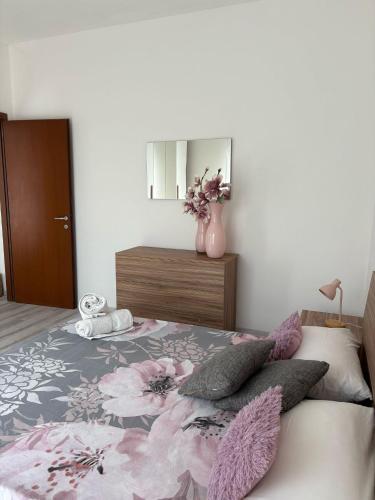 a bedroom with a bed with a vase of flowers at Miro' dreams in Alzate Brianza