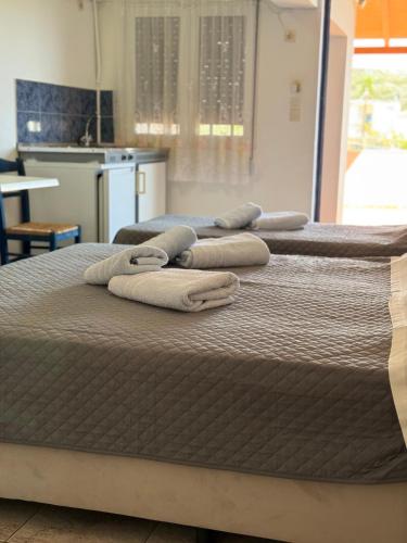 a group of three beds sitting in a room at Vias in Neapolis